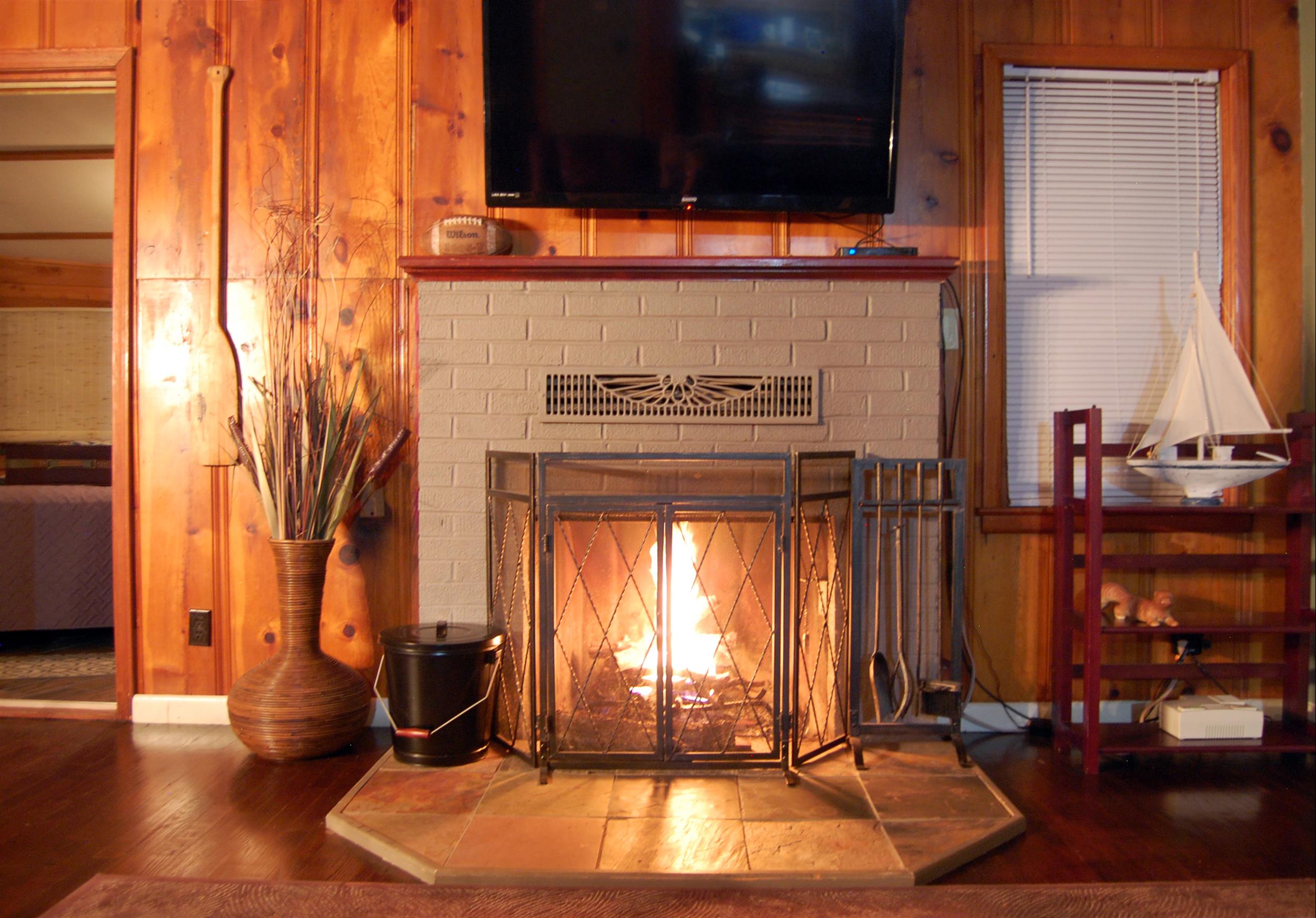 fire place with boat on shelf next to it